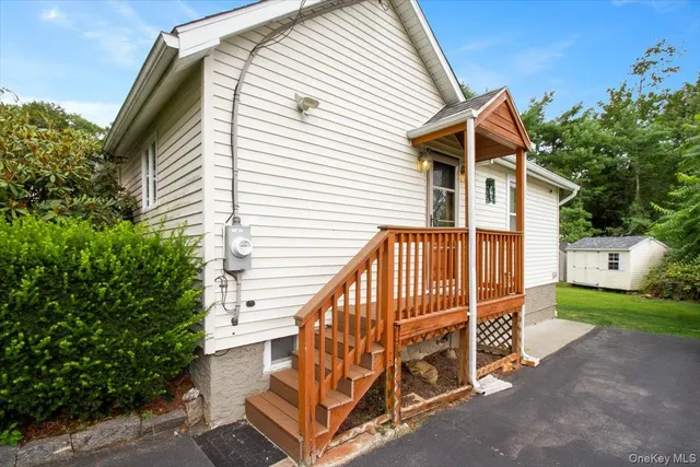 a view of backyard with deck and outdoor seating