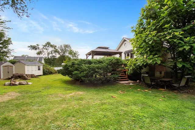 a view of a house with a yard and sitting area