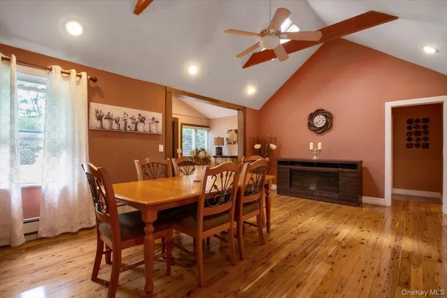 a dining room with furniture a chandelier and wooden floor