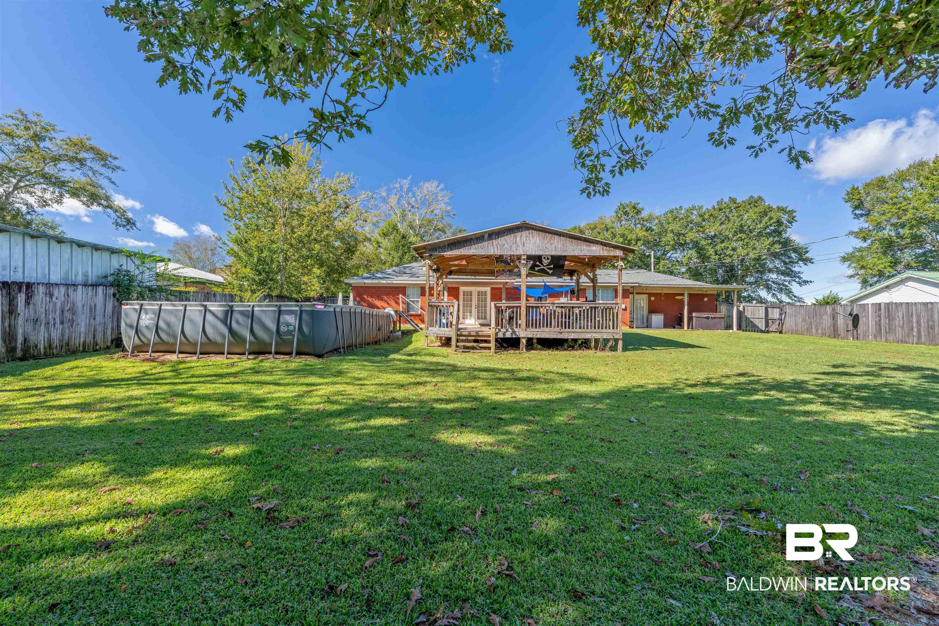 23186 Pecan Street Robertsdale, AL 36567 - Photo 24 of 36 Rear view of house featuring a deck and a fenced backyard