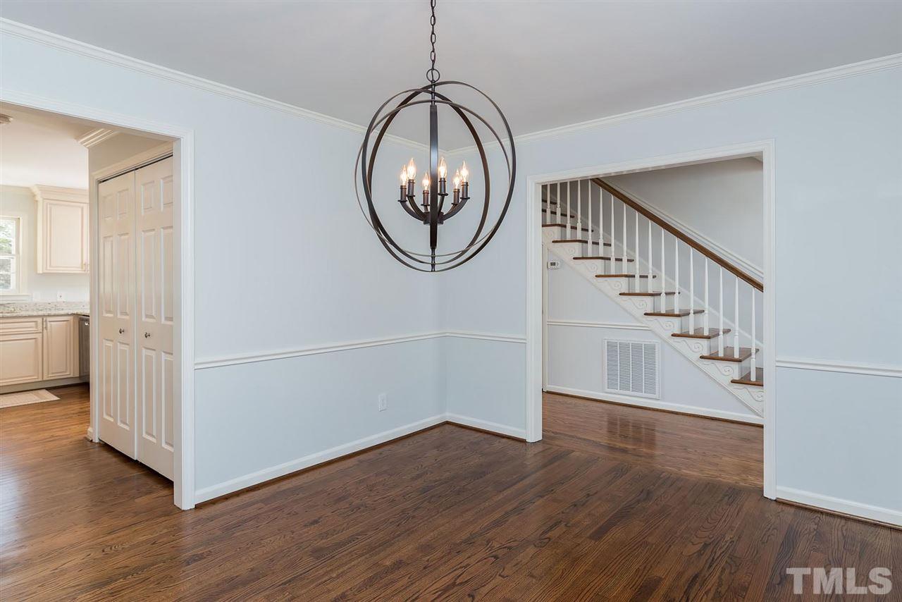 5828 Morning Forest Drive Raleigh, NC 27609 - Photo 2 of 25 a view of a livingroom with wooden floor and entryway