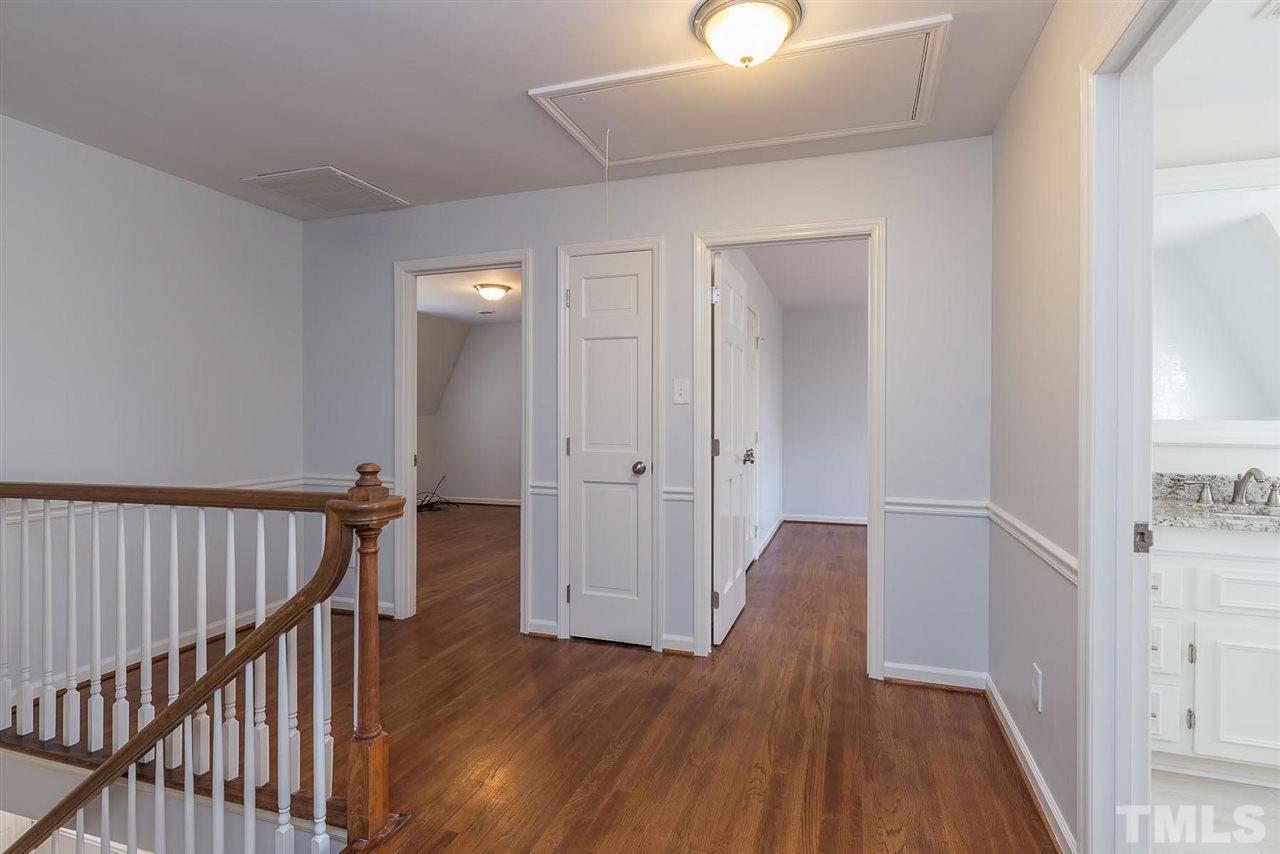 5828 Morning Forest Drive Raleigh, NC 27609 - Photo 13 of 25 a view of a hallway with wooden floor and staircase