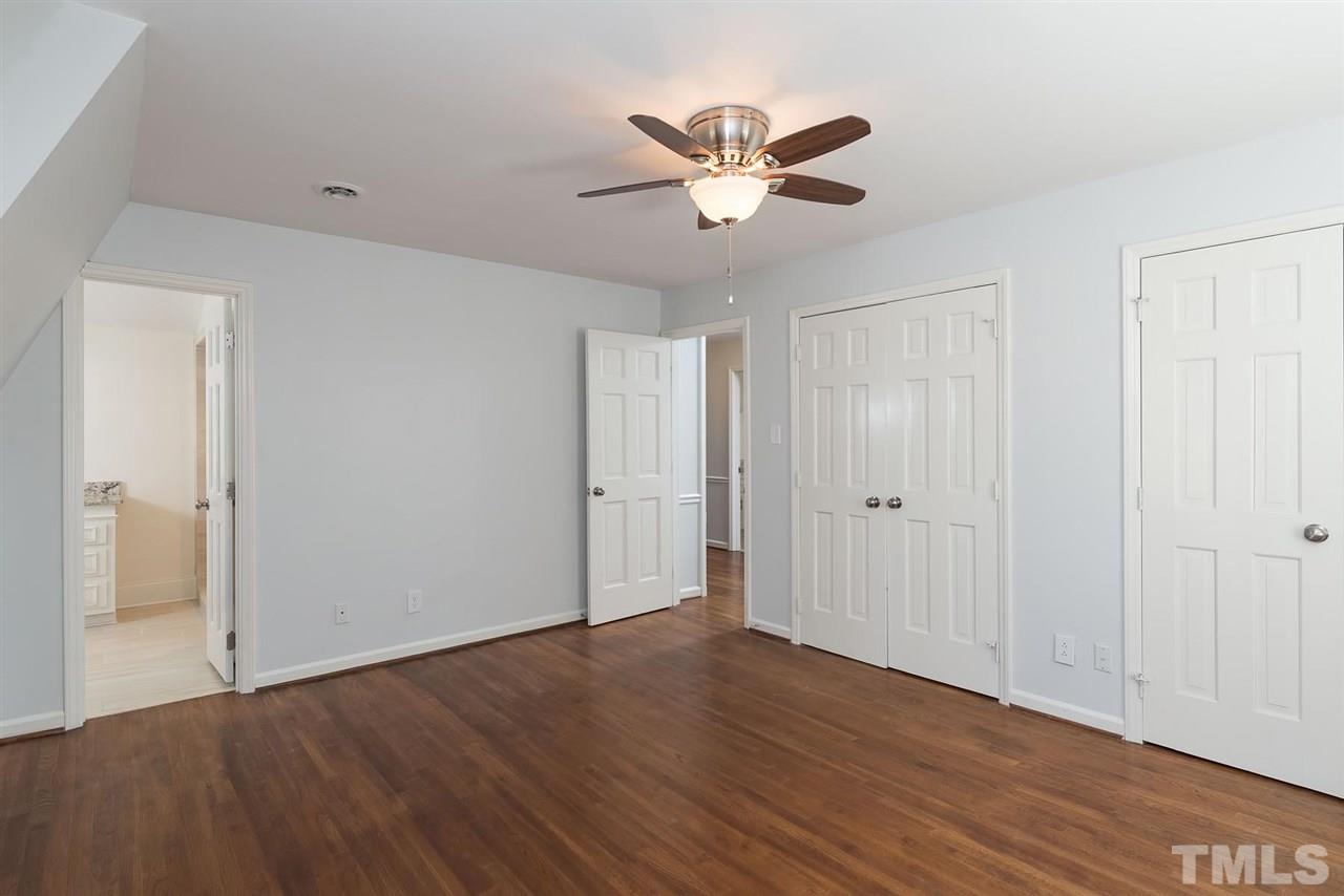 5828 Morning Forest Drive Raleigh, NC 27609 - Photo 15 of 25 a view of a room with wooden floor and white walls