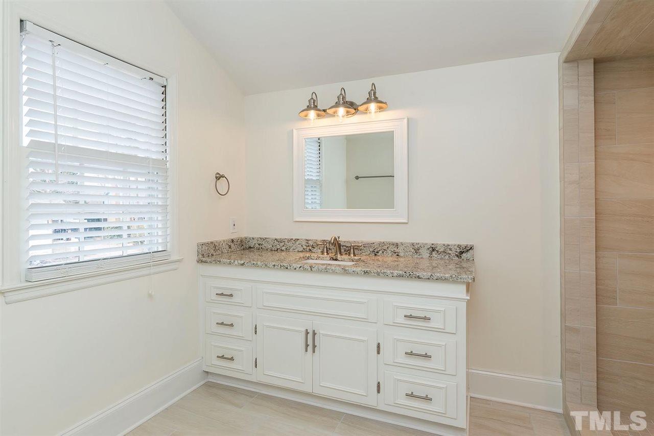 5828 Morning Forest Drive Raleigh, NC 27609 - Photo 16 of 25 a bathroom with a sink and a mirror