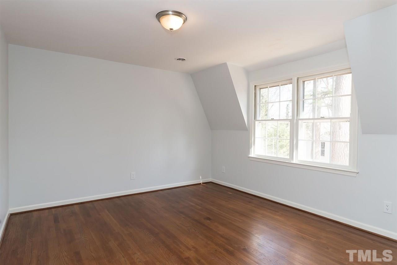 5828 Morning Forest Drive Raleigh, NC 27609 - Photo 20 of 25 an empty room with wooden floor and windows