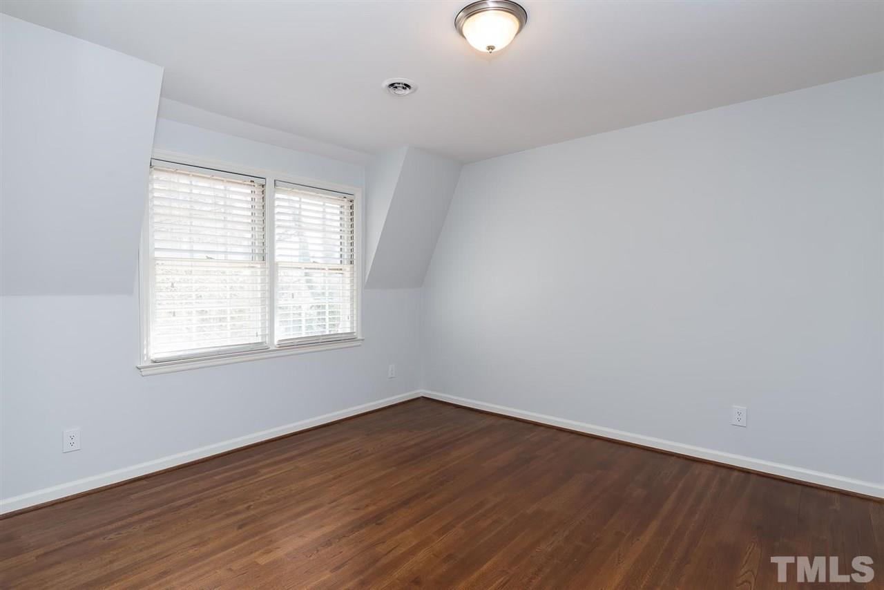 5828 Morning Forest Drive Raleigh, NC 27609 - Photo 21 of 25 an empty room with wooden floor and windows