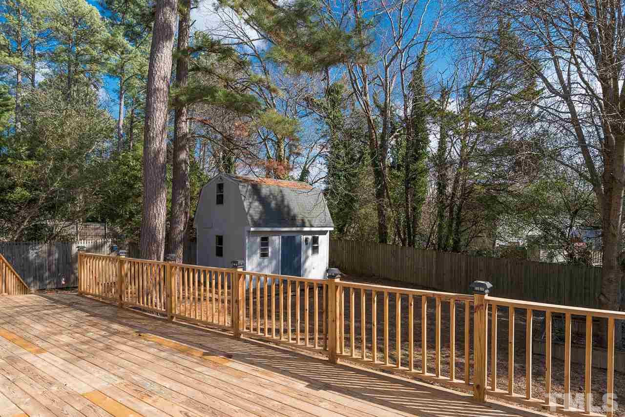 5828 Morning Forest Drive Raleigh, NC 27609 - Photo 23 of 25 a view of a wooden deck and trees