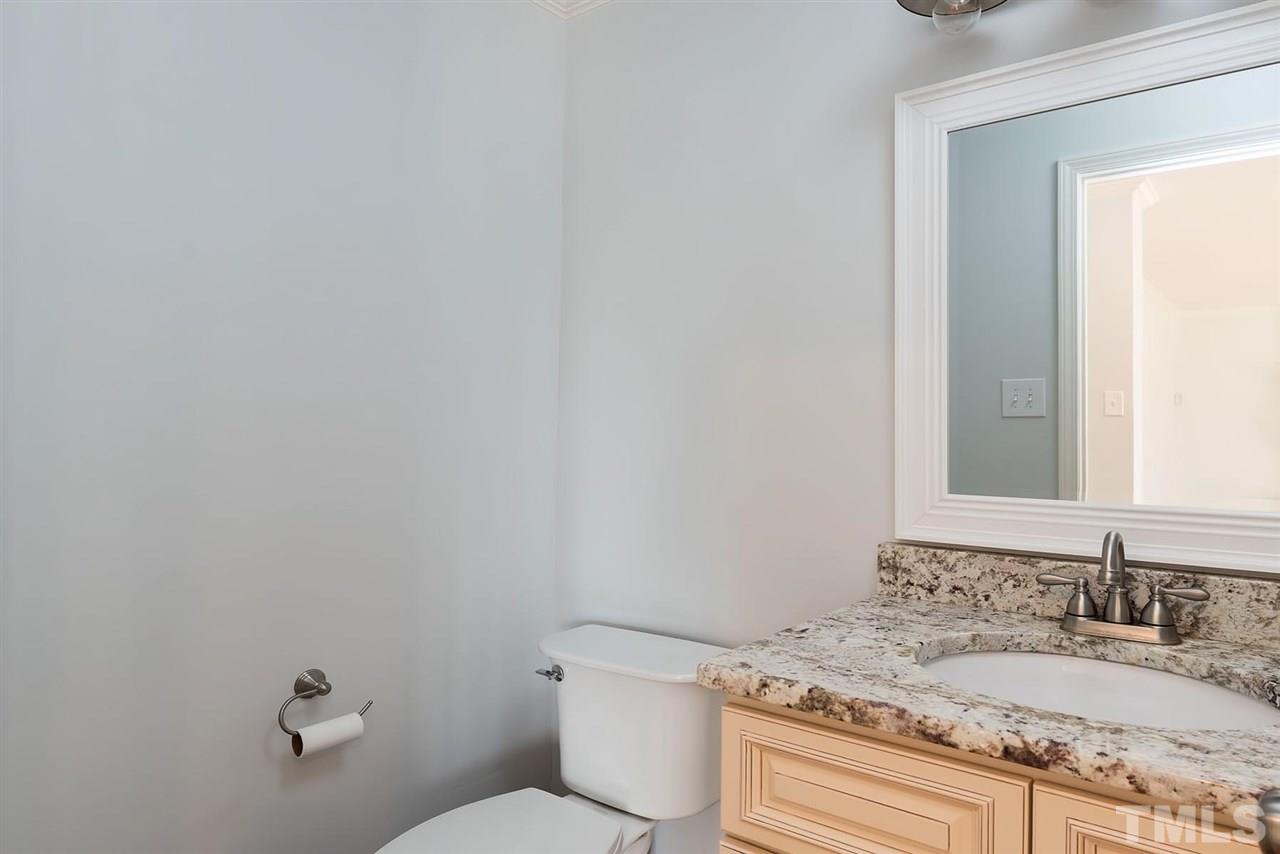 5828 Morning Forest Drive Raleigh, NC 27609 - Photo 9 of 25 a bathroom with a granite countertop sink and a mirror