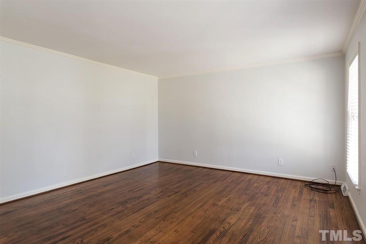 5828 Morning Forest Drive Raleigh, NC 27609 - Photo 10 of 25 a view of an empty room with wooden floor