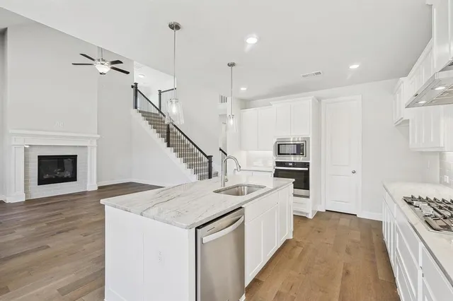 a kitchen with a stove a sink and a refrigerator