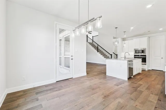 a view of kitchen with furniture and wooden floor