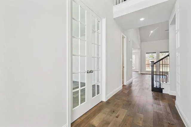 a view of a hallway with wooden floor and entryway
