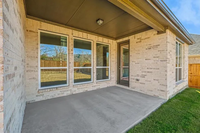 a view of an entrance to house with yard