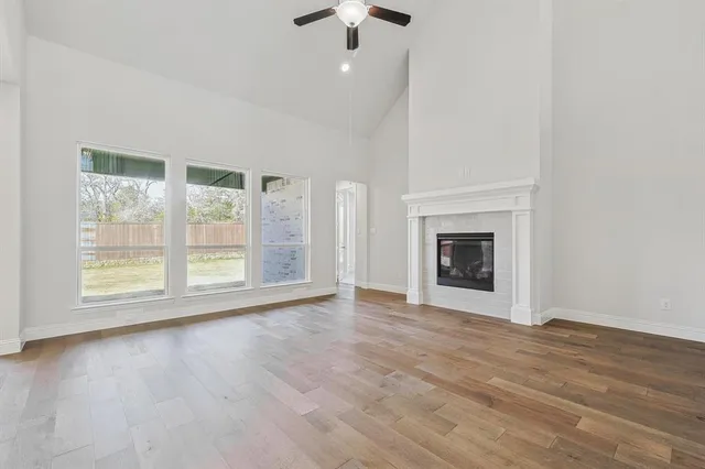 wooden floor fireplace and natural light in room