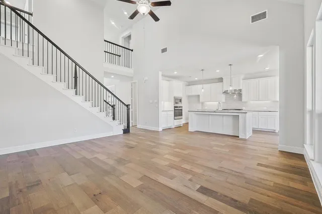 a view of a kitchen with wooden floor and electronic appliances
