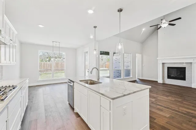 a kitchen with a stove a sink and a refrigerator