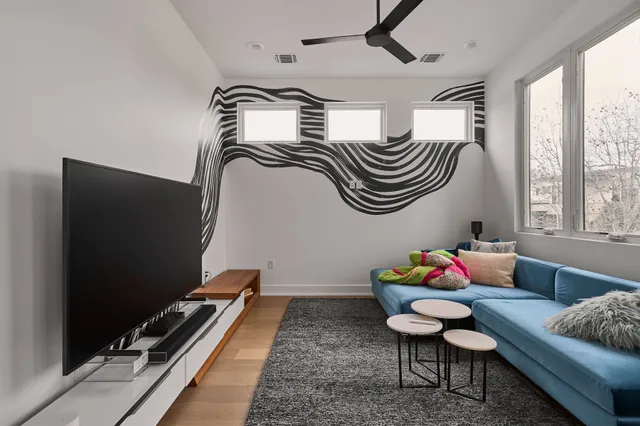 a bedroom with furniture and a flat screen tv