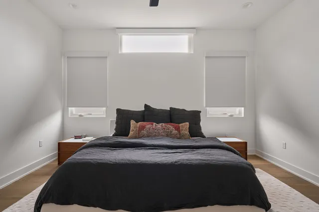 a bedroom with a bed and a night stand