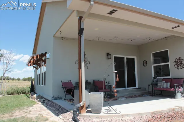a view of a patio with a table and chairs