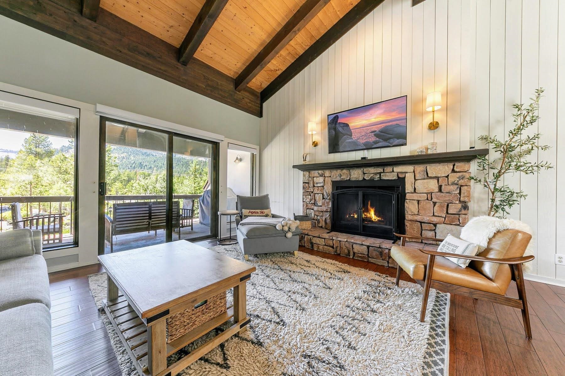 a living room with furniture a flat screen tv and a fireplace