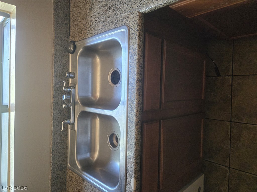 7200 West Pirates Cove Road, Unit 2047 Las Vegas, NV 89145 - Photo 12 of 17 Double stainless steel sinks with ample counter space are ideal for culinary tasks.
