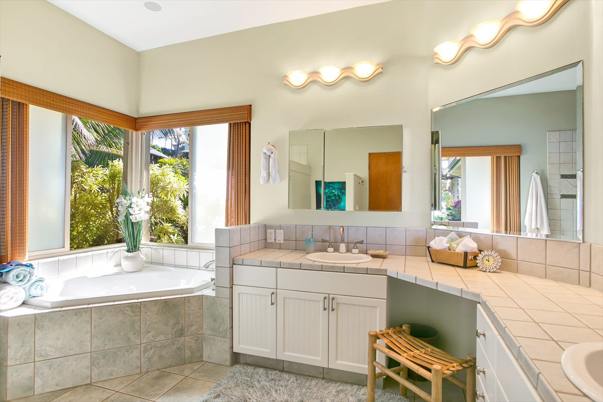 1811 Pe'e Road Koloa, HI 96756 - Photo 13 of 25 a spacious bathroom with a double vanity sink a large mirror and a bathtub