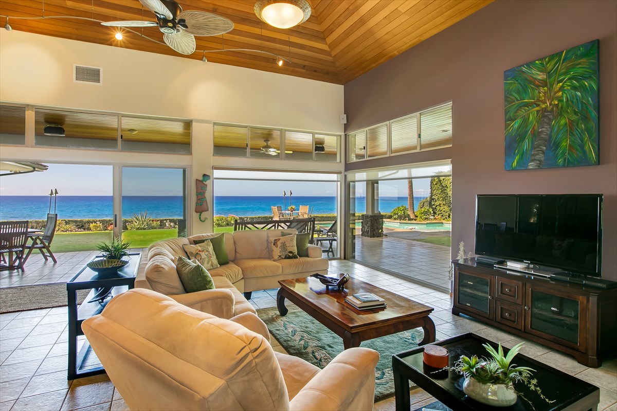 1811 Pe'e Road Koloa, HI 96756 - Photo 7 of 25 a living room with furniture a flat screen tv and floor to ceiling window