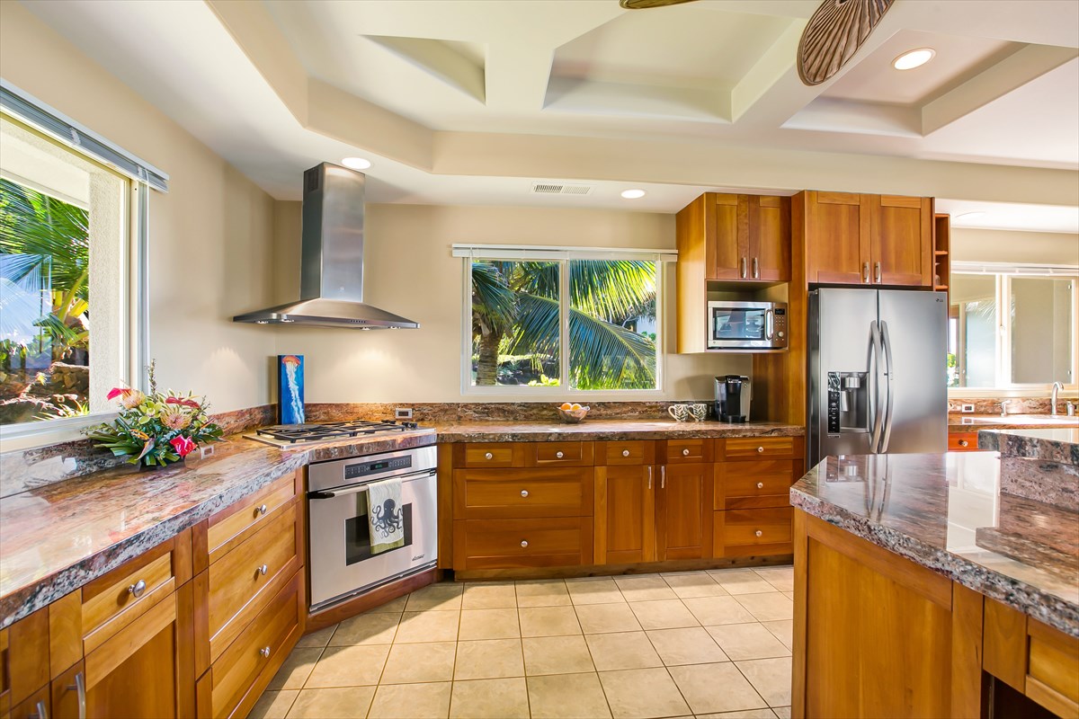 1811 Pe'e Road Koloa, HI 96756 - Photo 9 of 25 a kitchen with stainless steel appliances granite countertop a stove a sink dishwasher and a refrigerator