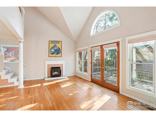 a view of an empty room with a fireplace and a window