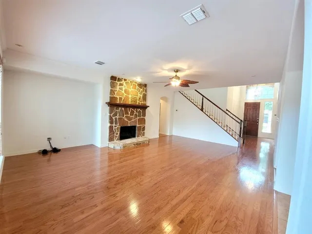 a view of a room with wooden floor and chandelier