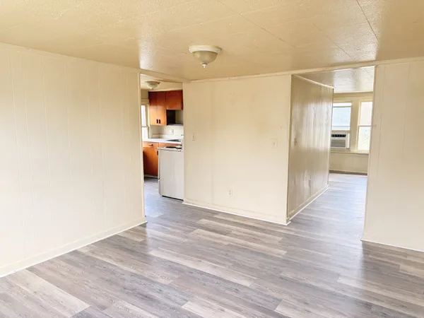 a view of a refrigerator in kitchen and wooden floor