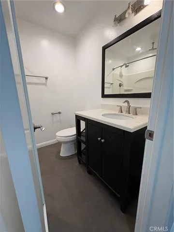 a bathroom with a sink toilet and mirror