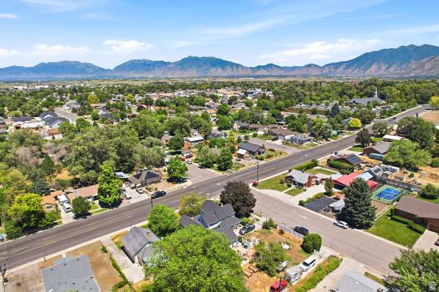 310 South 300 West Payson, UT 84651 - Photo 41 of 42 Expansive aerial perspective showcasing a residential neighborhood with broad streets, mature tree canopies, and mountainous terrain in the background