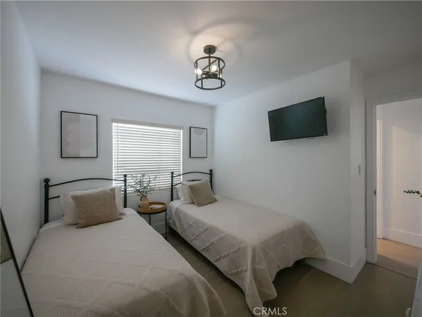 a bedroom with a bed and a flat screen tv