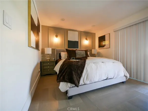 a bedroom with a bed and lamp with window