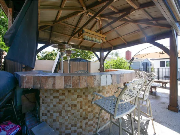 a view of patio with table and chairs under an umbrella