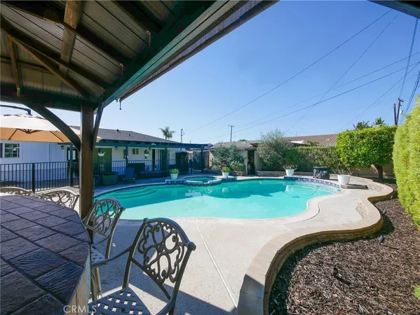a view of a porch with furniture and garden