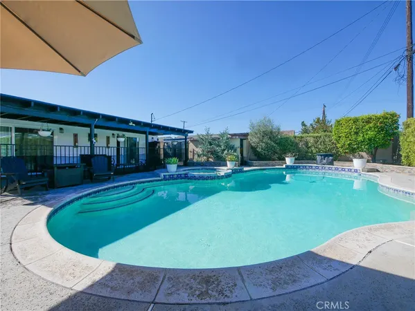 a view of a swimming pool with a patio