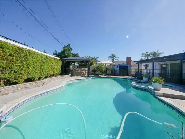 a swimming pool with outdoor seating and yard