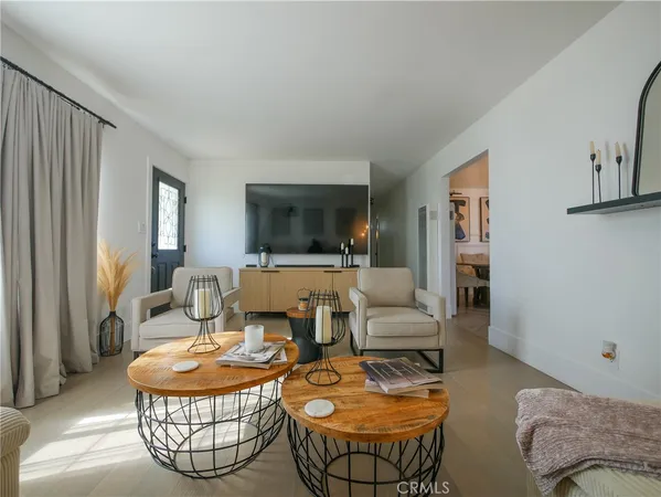 a living room with furniture a rug and a chandelier