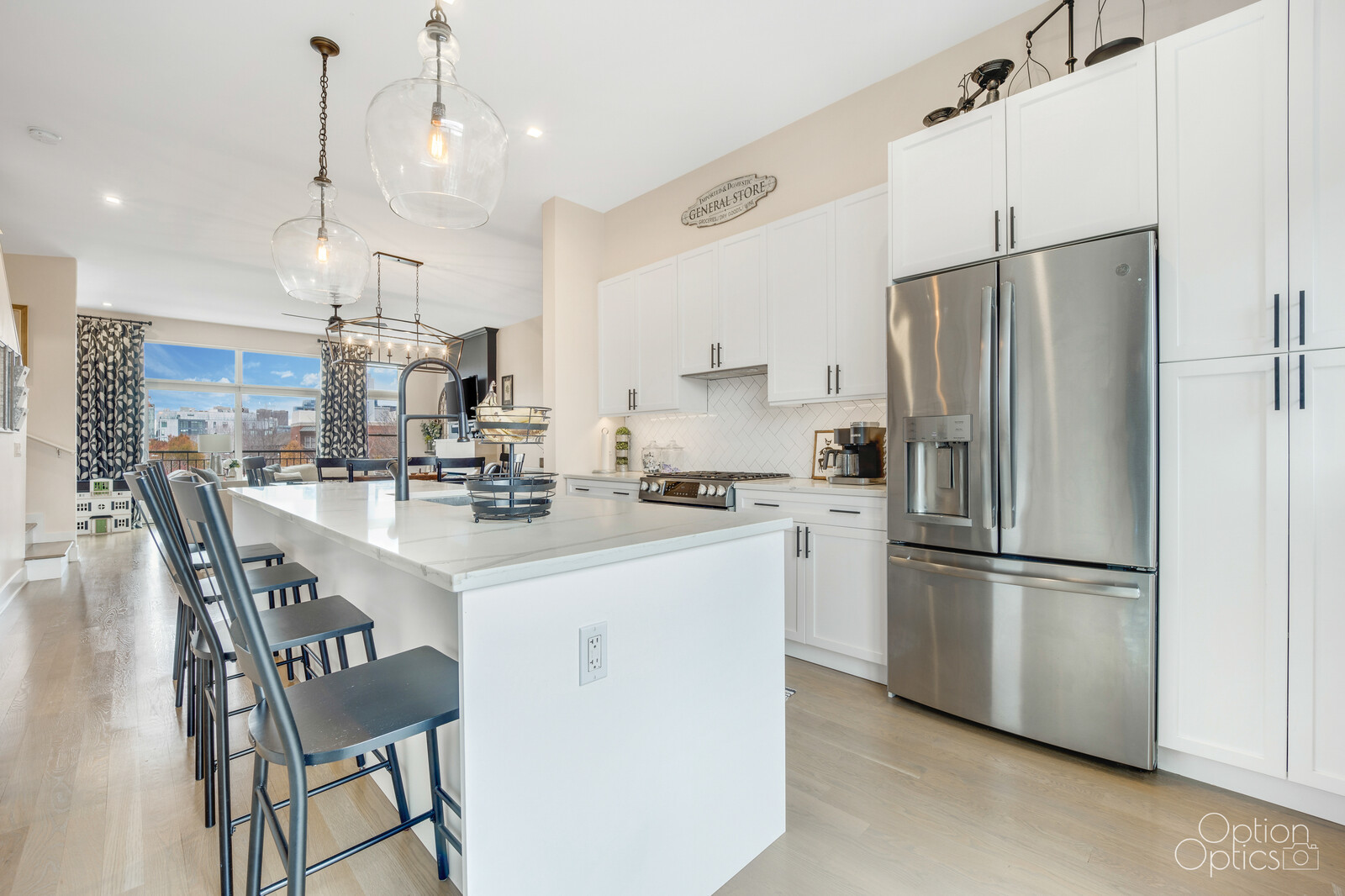 733 West 15th Street Chicago, IL 60607 - Photo 10 of 34 a kitchen with stainless steel appliances a refrigerator a sink a stove a dining table and chairs