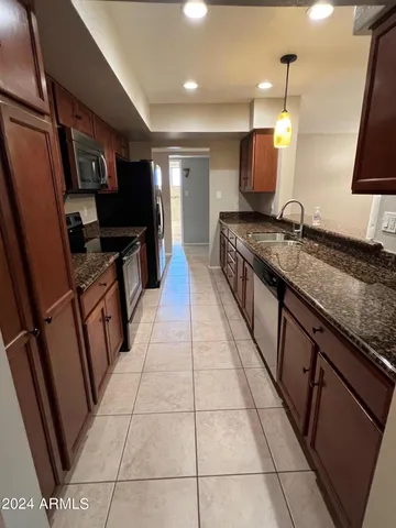a large kitchen with a sink and a stove top oven