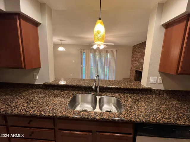 a bathroom with a granite countertop sink a mirror and vanity