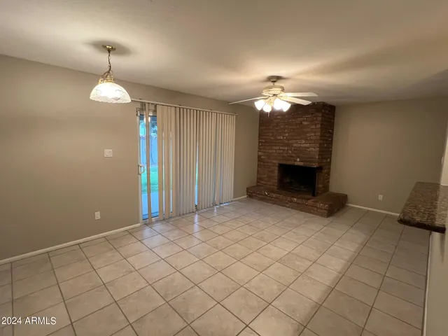 a view of an empty room with a fireplace