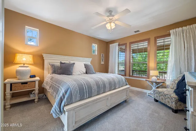 a view of an empty room and chandelier fan