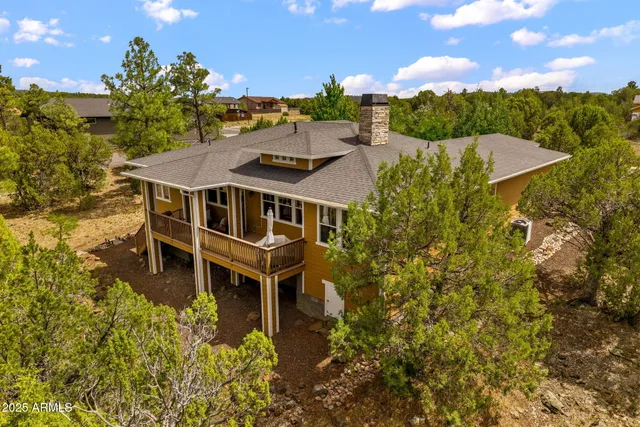 a aerial view of a house with a yard basket ball court and outdoor seating