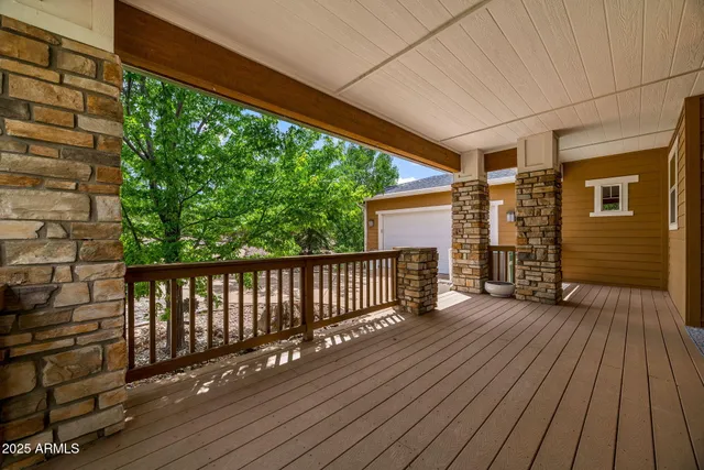 a front view of a house with a tree