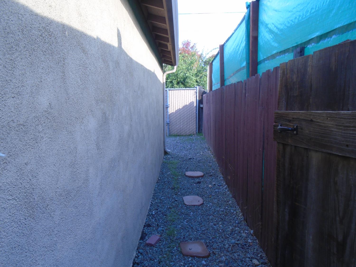 322 Johnson Street Modesto, CA 95354 - Photo 3 of 6 a view of a pathway gate with wooden fence