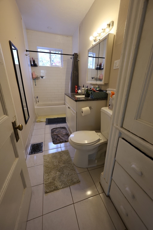 33-35 Ridgemont Street, Unit 1 Boston, MA 02134 - Photo 5 of 10 a bathroom with a toilet and a mirror