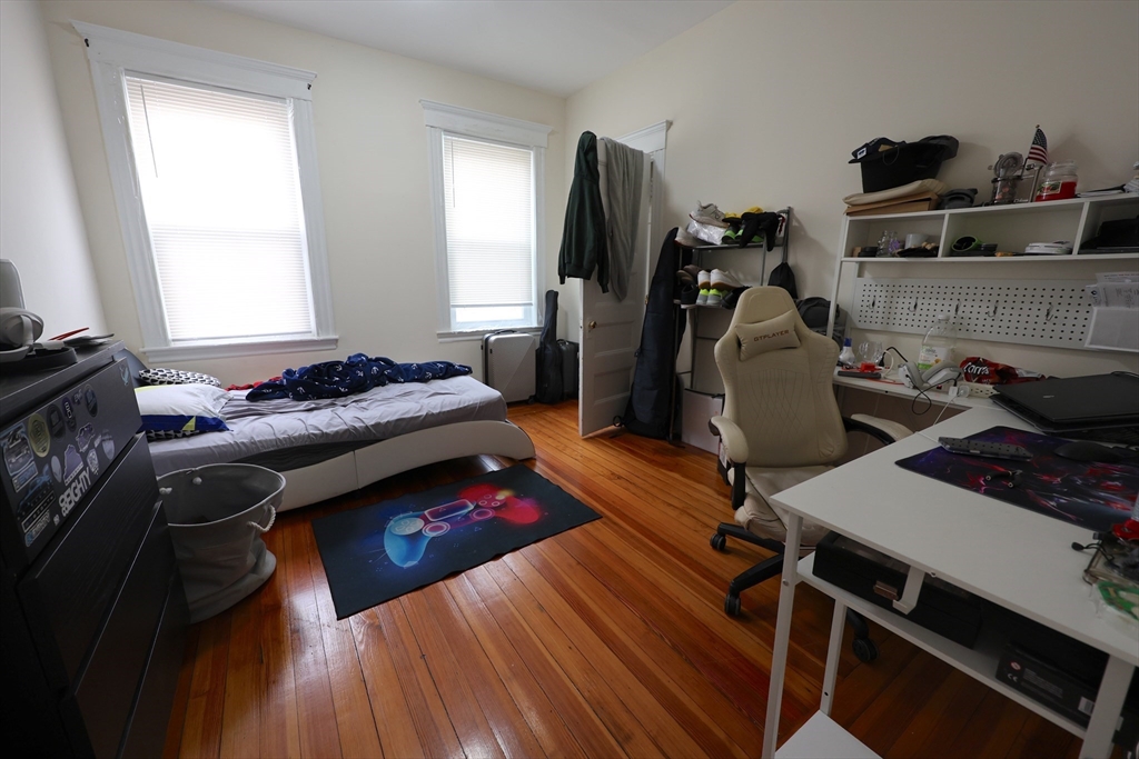 33-35 Ridgemont Street, Unit 1 Boston, MA 02134 - Photo 6 of 10 a bedroom with furniture and a window